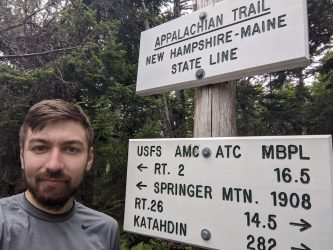 Alan crosses the New Hampshire and Maine state line along the Appalachian Trail