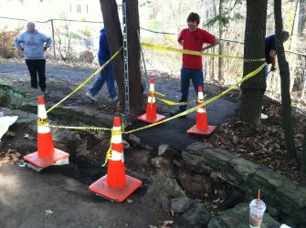 Alan stands next to his nearly completed path, which is temporarily roped off to prevent any injuries until the new bridge can be installed.