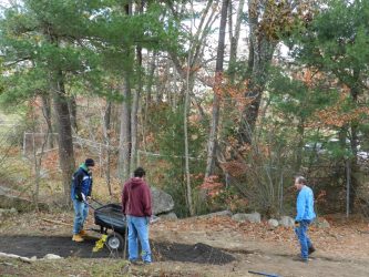Boyscouts from Troop 21 add material to the path to ensure that no weeds grow in the future.