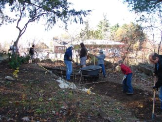 Boyscouts from Troop 21 remove the rocky dirt and soil to be replaced with RAP (recycled asphalt) so that no new plants will grow in the spring.