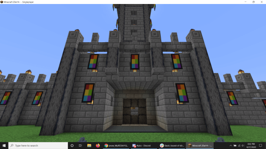 Alan's first Minecraft base, showcasing his flag banner and the wall design and castle keep for entering and leaving the base.